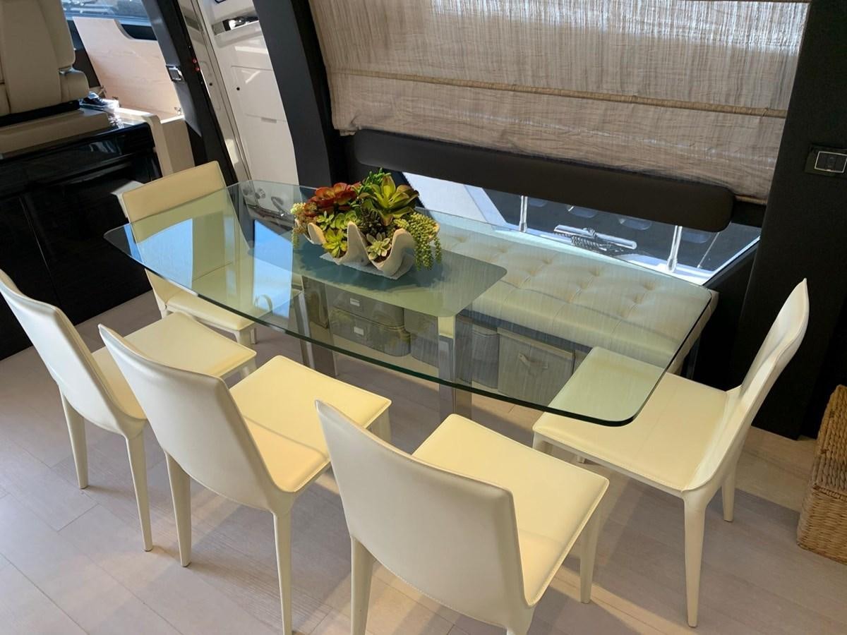 a table with chairs around it aboard AMALFI Yacht for Sale
