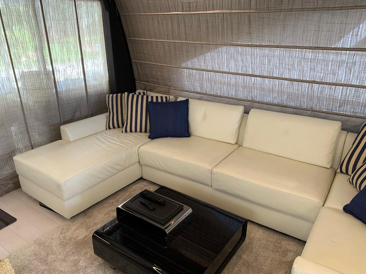 a couch with a coffee table aboard AMALFI Yacht for Sale
