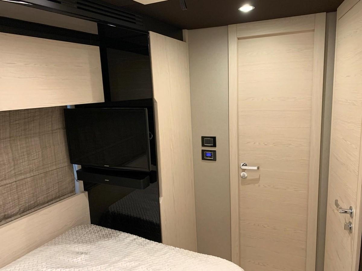 a room with a tv and a bed aboard AMALFI Yacht for Sale