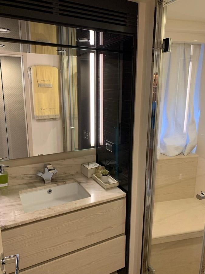 a bathroom with a sink and a mirror aboard AMALFI Yacht for Sale