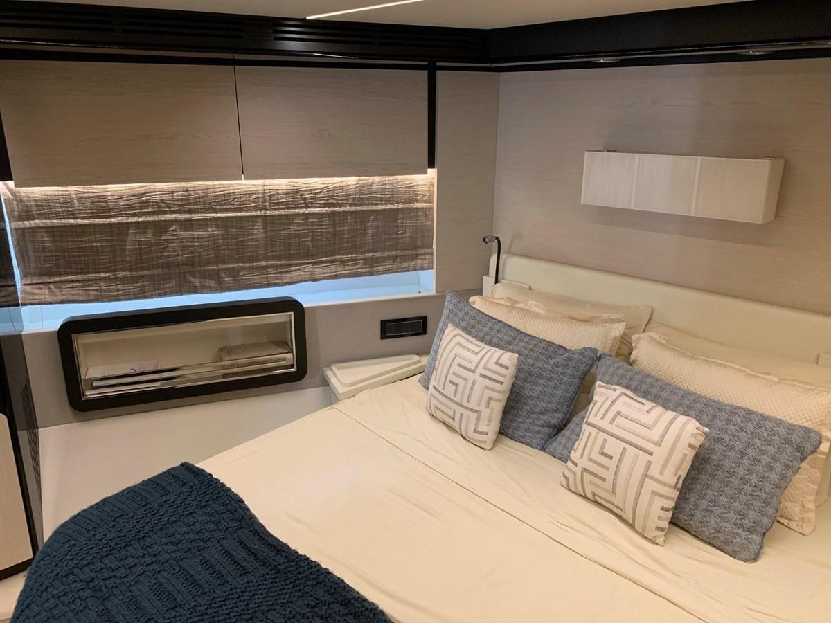 a room with a bed and a television aboard AMALFI Yacht for Sale