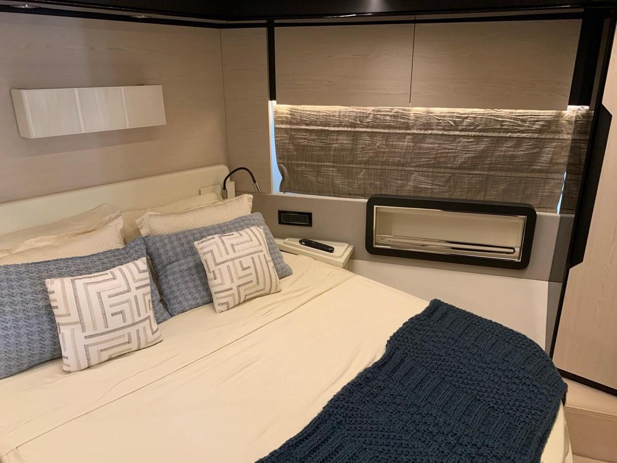 a bed with pillows and a television aboard AMALFI Yacht for Sale