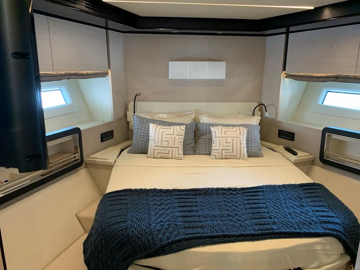 a bed with blue sheets aboard AMALFI Yacht for Sale