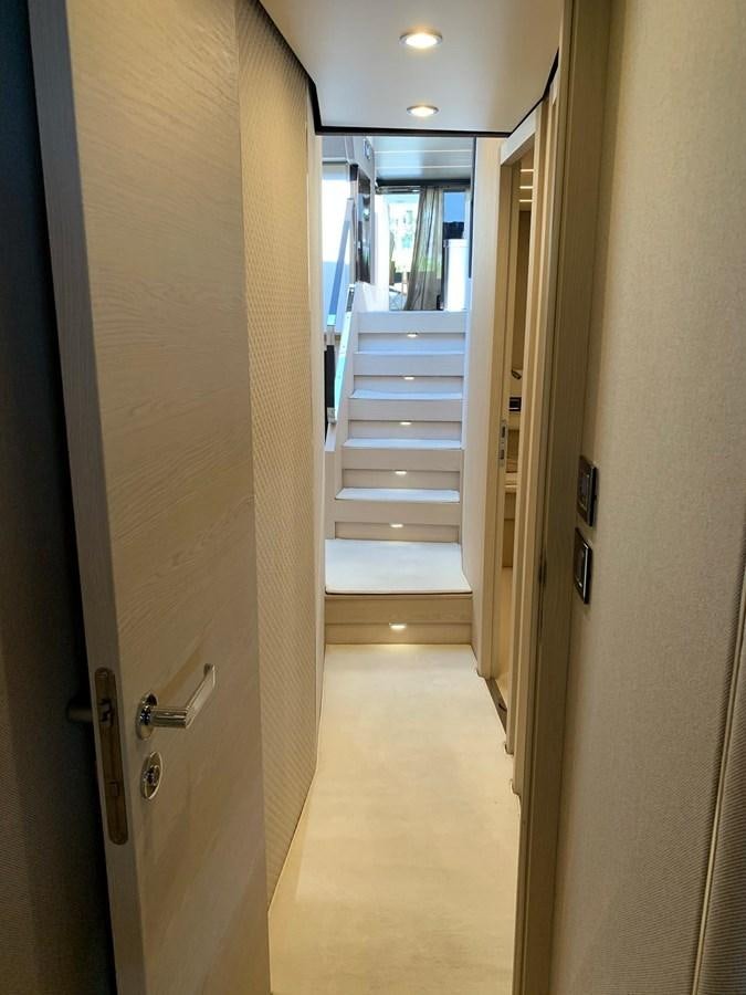 a hallway with a door and a glass door aboard AMALFI Yacht for Sale