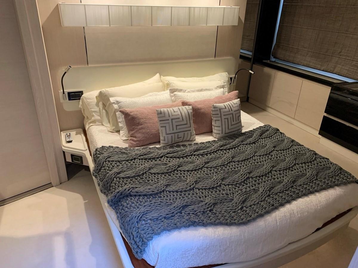a bed with a pillow on it aboard AMALFI Yacht for Sale