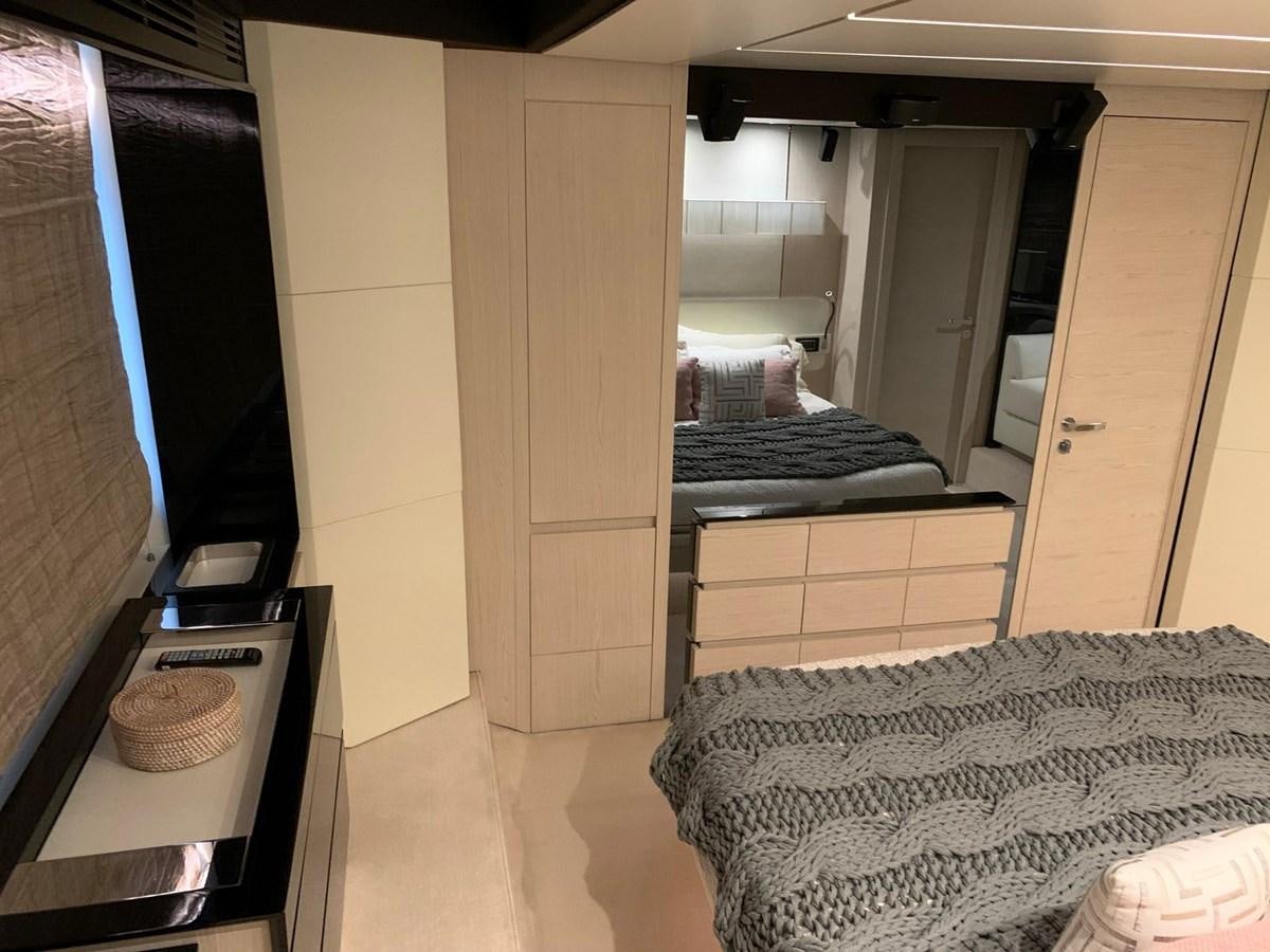 a bedroom with a bed and a desk aboard AMALFI Yacht for Sale