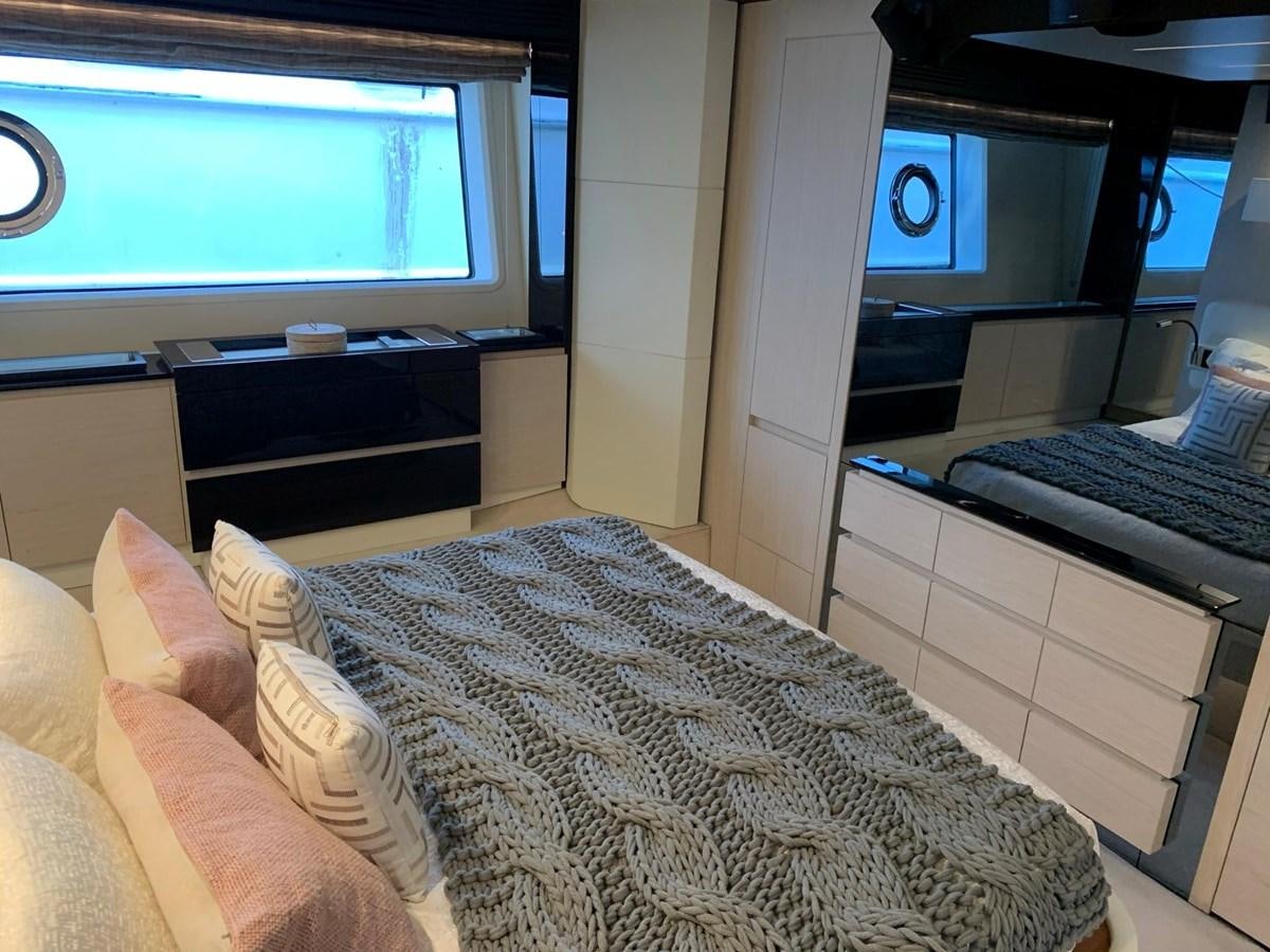 a bedroom with a bed and a desk aboard AMALFI Yacht for Sale