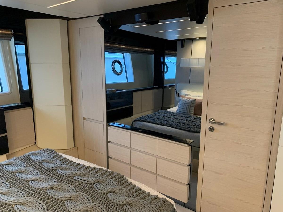 a bedroom with a bed and a desk aboard AMALFI Yacht for Sale