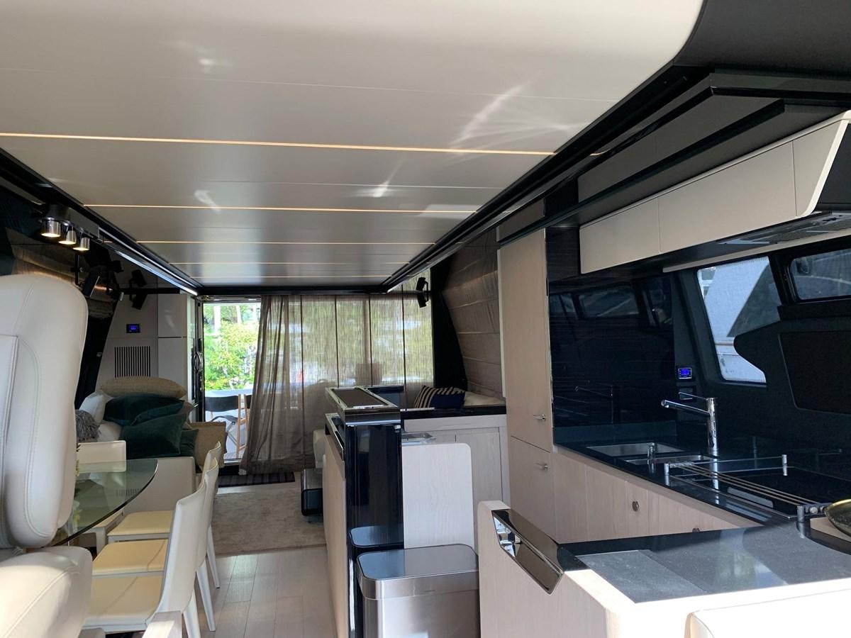 a room with a large tv and a table and chairs aboard AMALFI Yacht for Sale