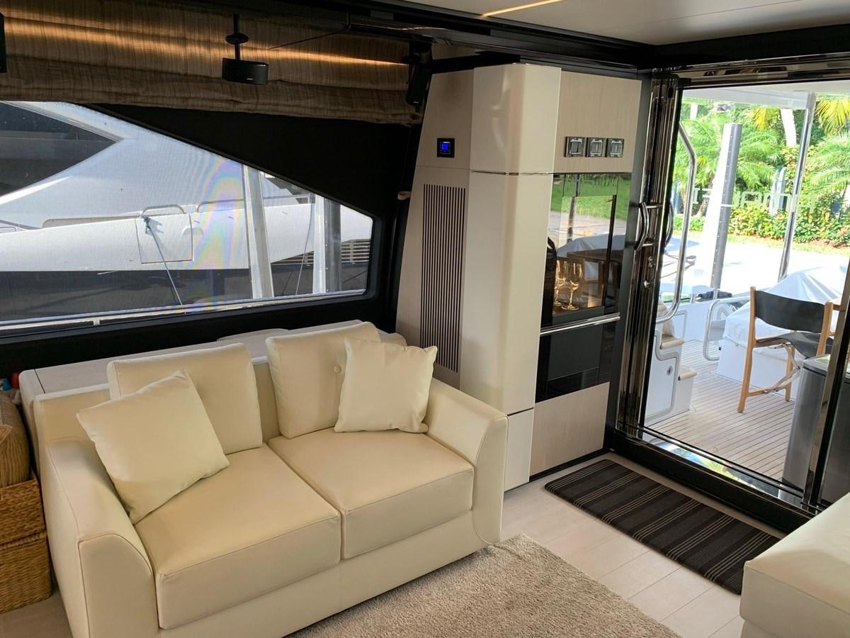 a living room with a sliding glass door aboard AMALFI Yacht for Sale