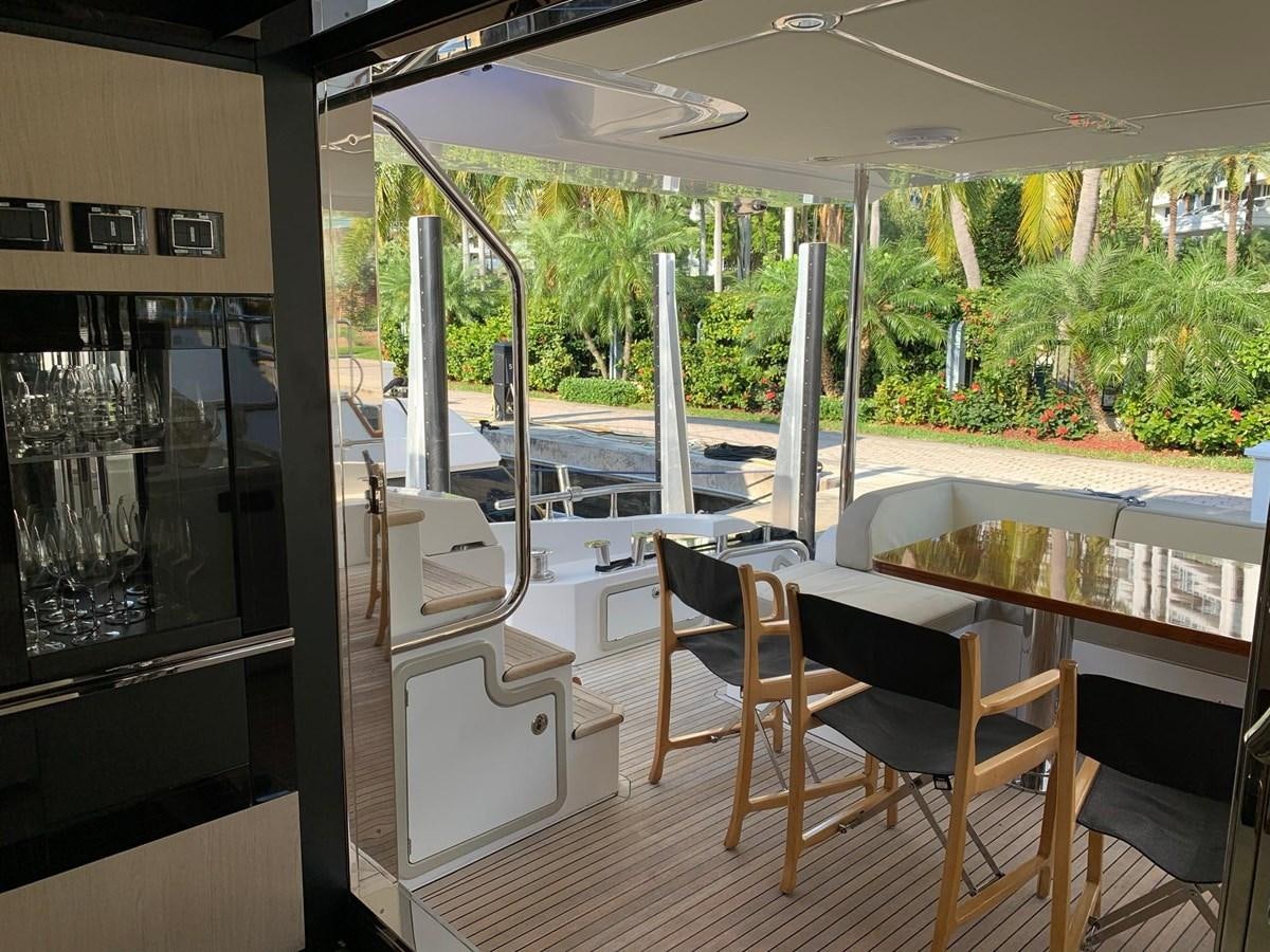 a deck with a view of the trees and the pool aboard AMALFI Yacht for Sale
