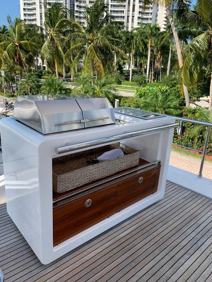 a deck with a grill and trees aboard AMALFI Yacht for Sale