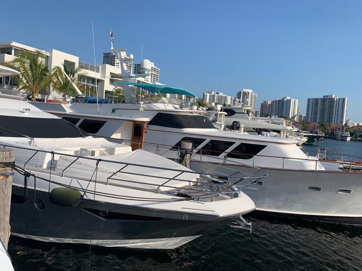 a white yacht on a dock aboard AMALFI Yacht for Sale