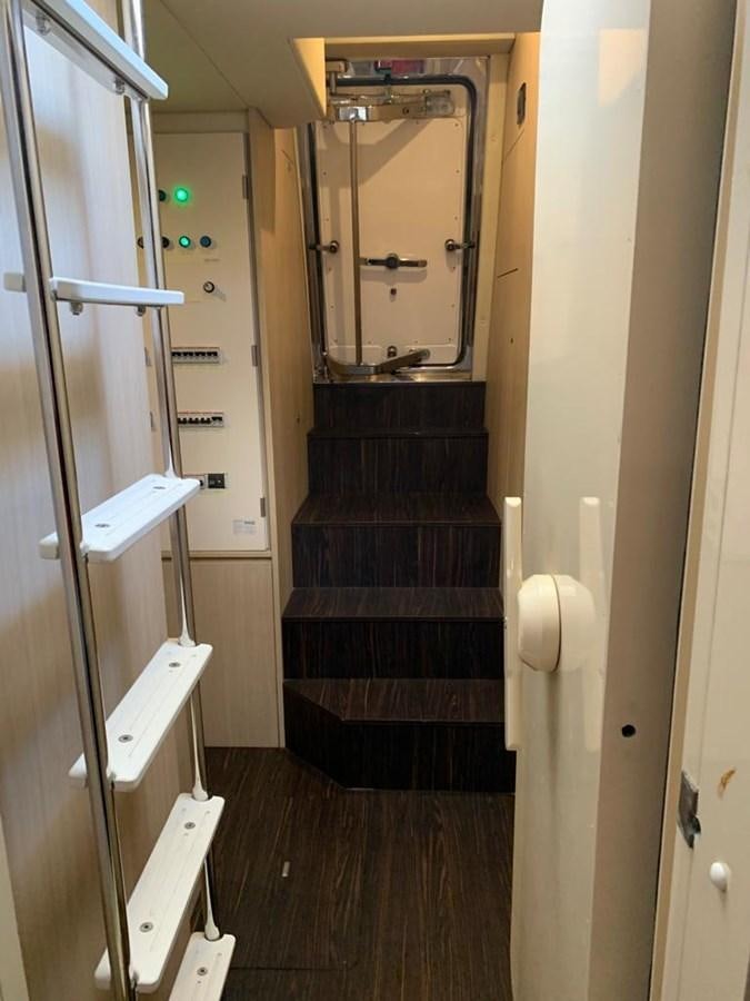 a bathroom with a wood door aboard AMALFI Yacht for Sale