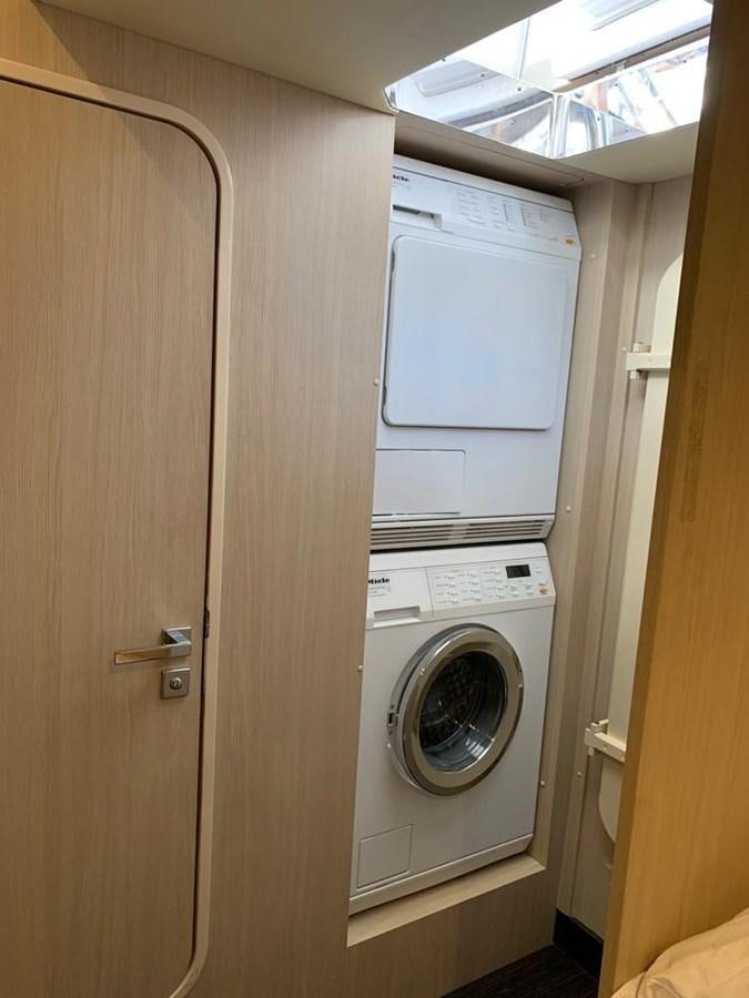 a closet with a washing machine aboard AMALFI Yacht for Sale