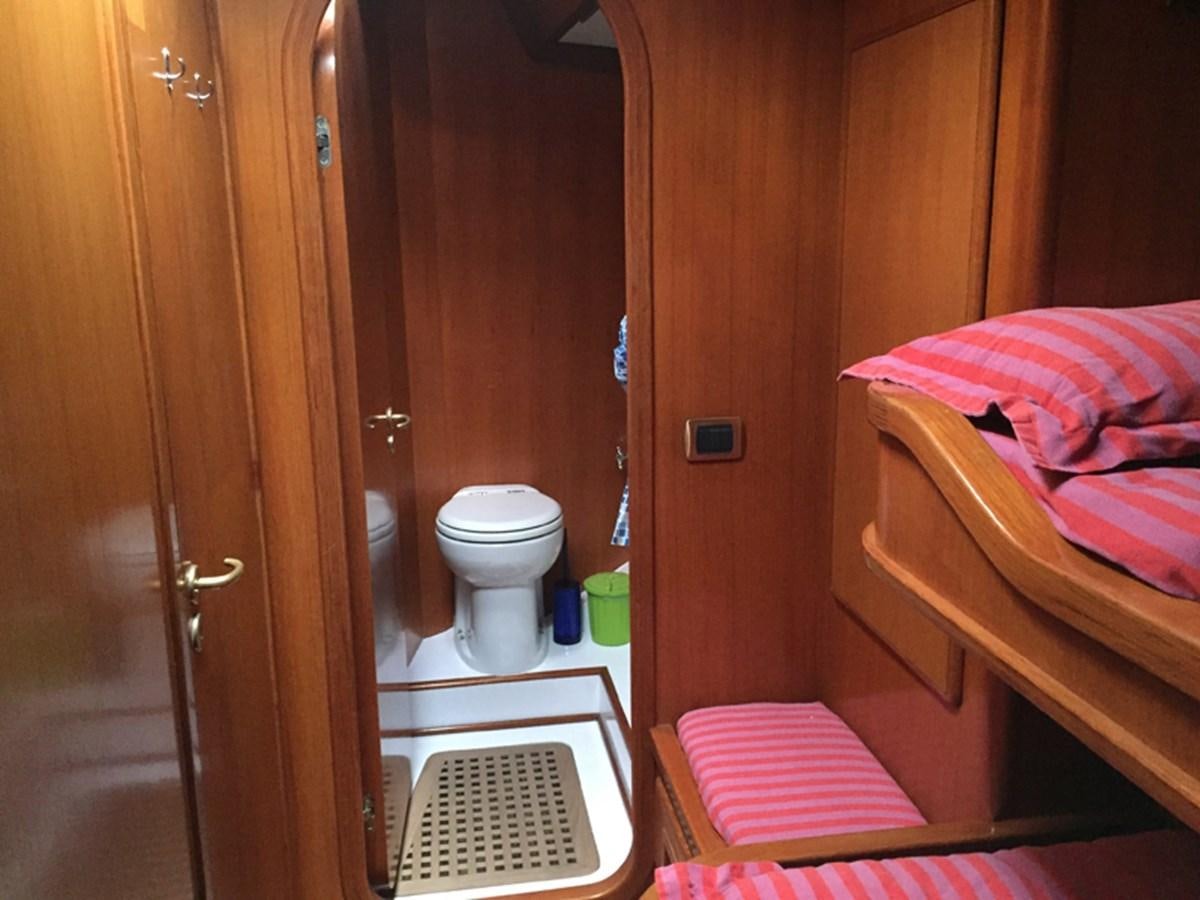a bathroom with a toilet and a bed aboard MORGANA Yacht for Sale