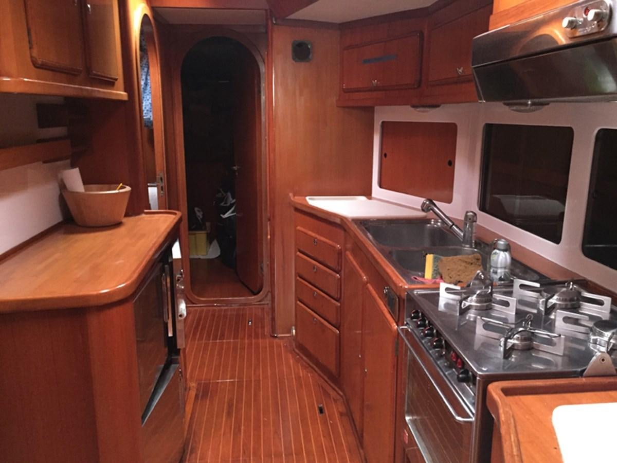 a kitchen with wooden cabinets aboard MORGANA Yacht for Sale