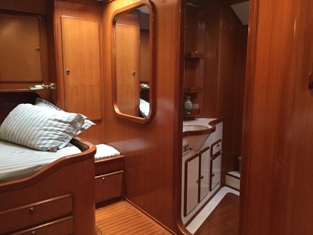 a room with a bed and a mirror aboard MORGANA Yacht for Sale