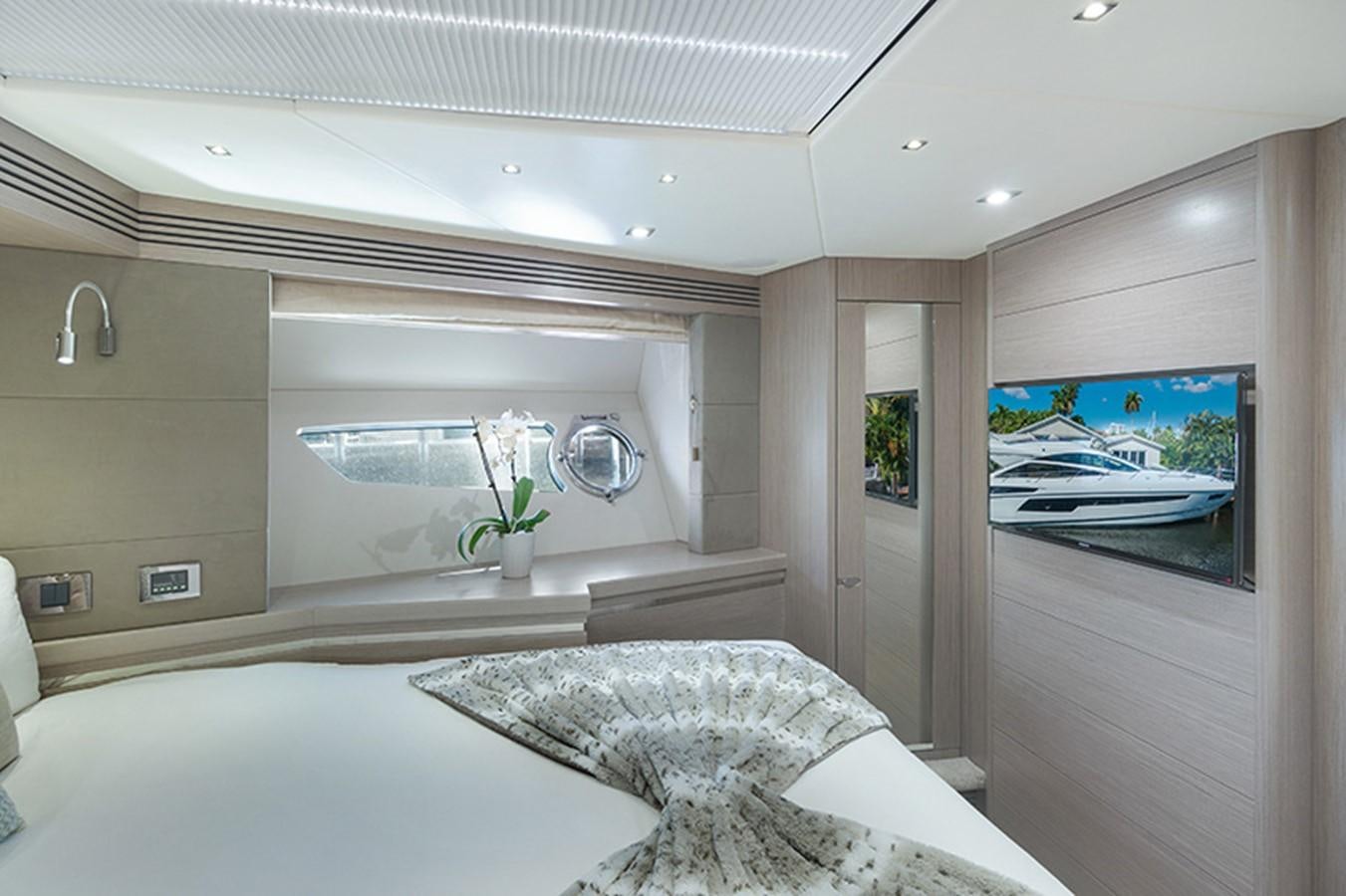 a room with a bed and a television aboard LONG WAY ROUND Yacht for Sale