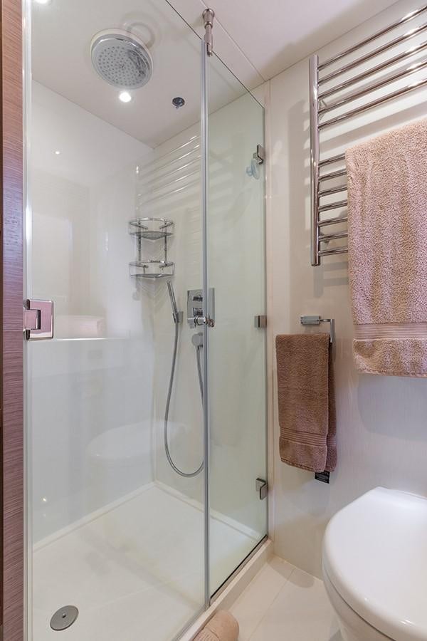 a bathroom with a glass shower aboard LONG WAY ROUND Yacht for Sale