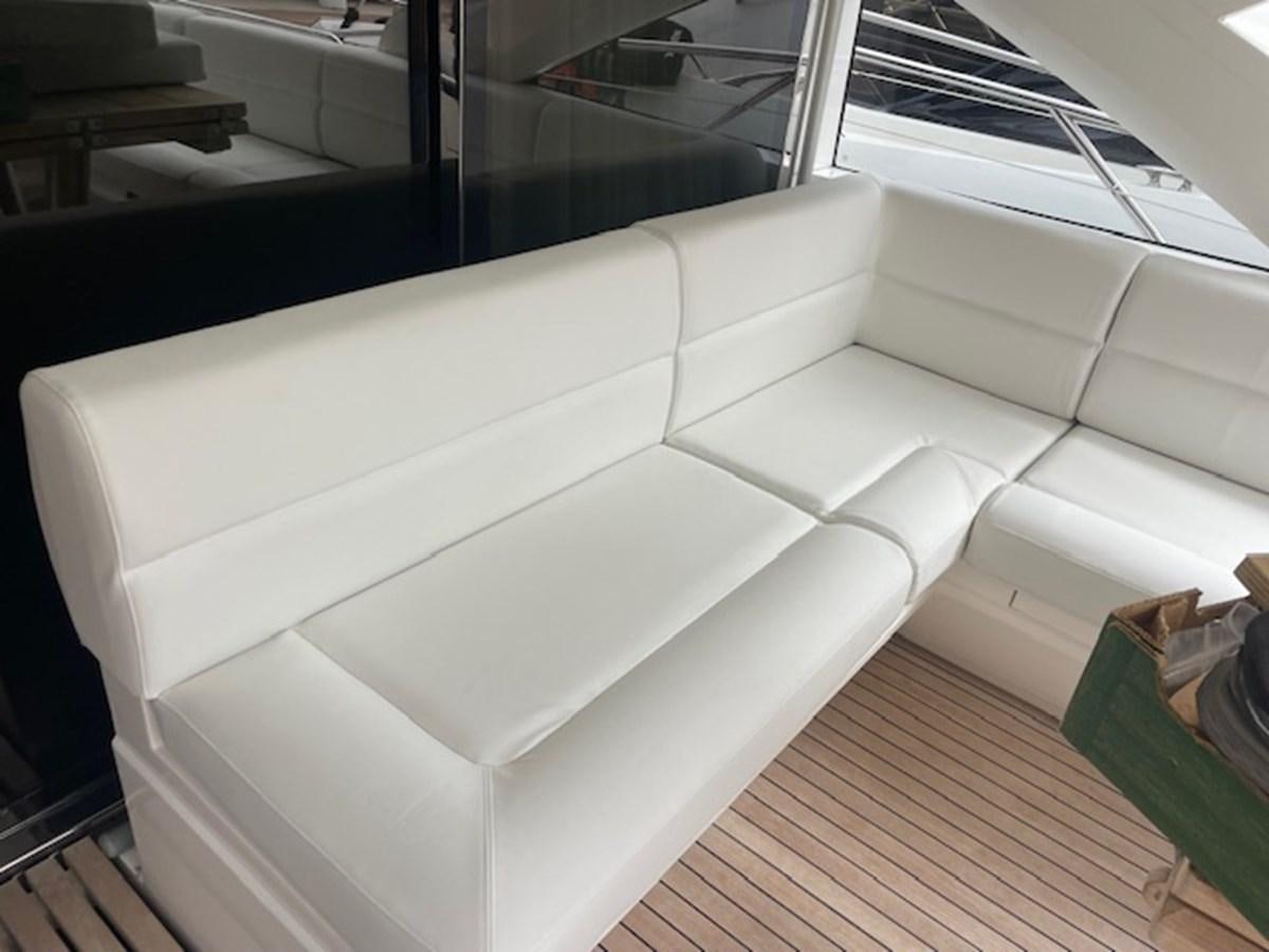 a white couch in a room aboard LONG WAY ROUND Yacht for Sale