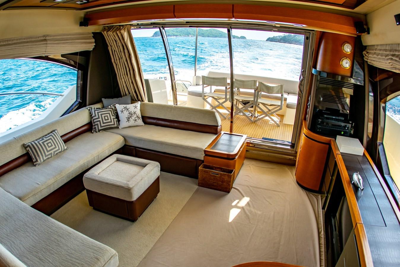 a living room with a couch and a tv aboard VA BENE 2011 AZIMUT 70 FLY Yacht for Sale