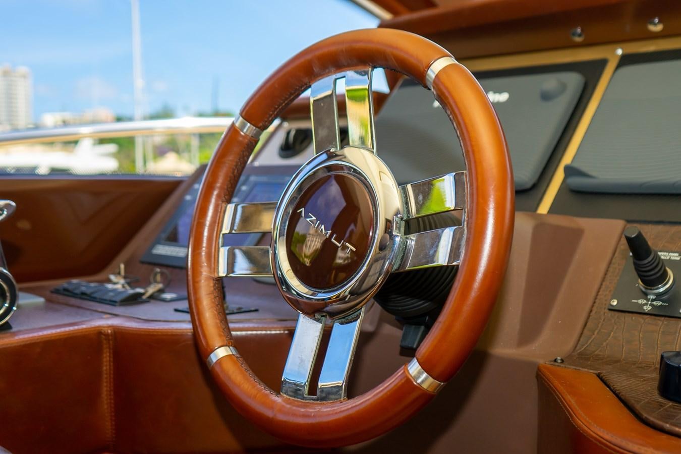 the steering wheel of a car aboard VA BENE 2011 AZIMUT 70 FLY Yacht for Sale
