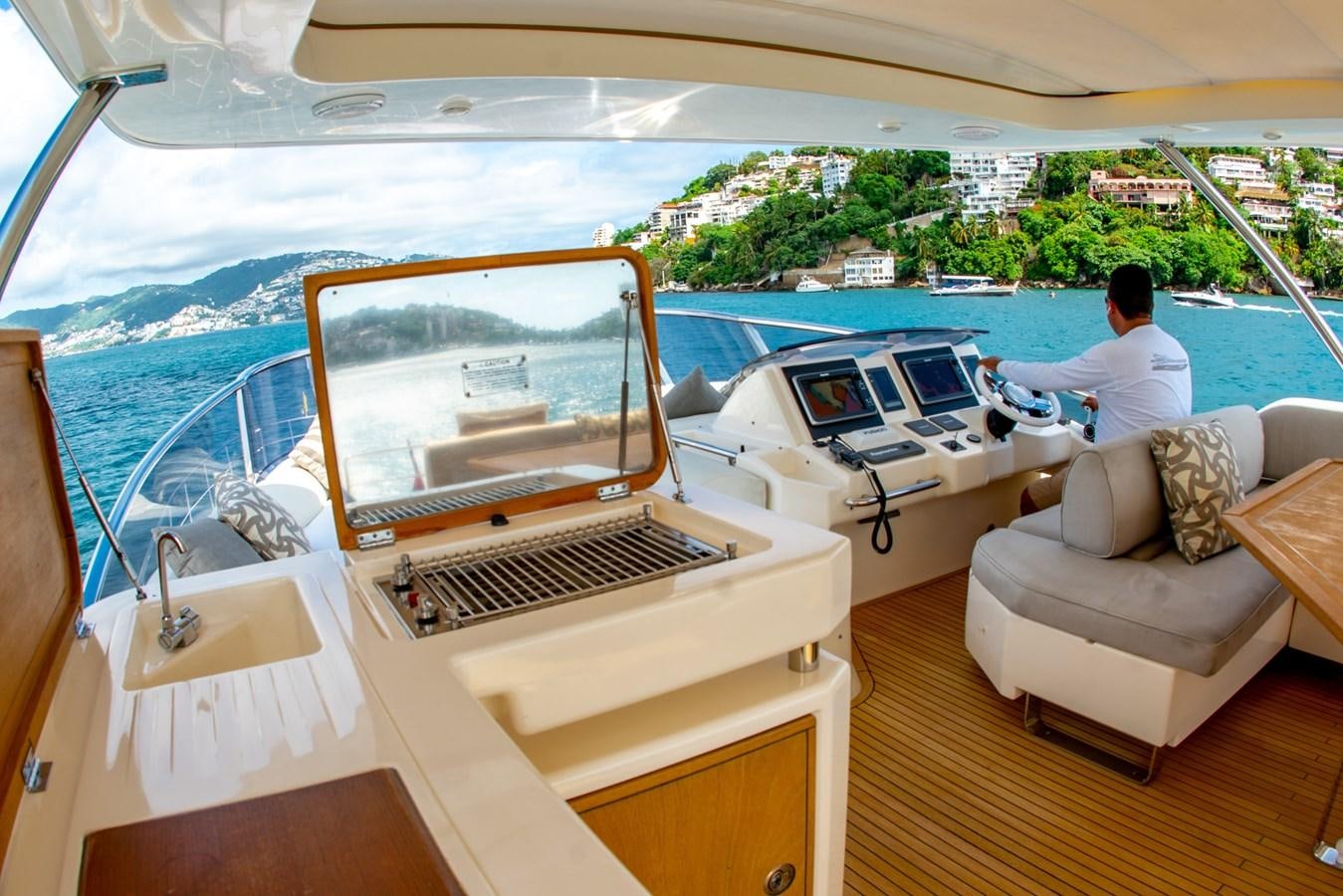 a person sitting on a boat aboard VA BENE 2011 AZIMUT 70 FLY Yacht for Sale