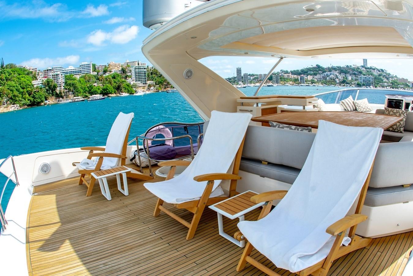 a deck with chairs and a body of water in the background aboard VA BENE 2011 AZIMUT 70 FLY Yacht for Sale