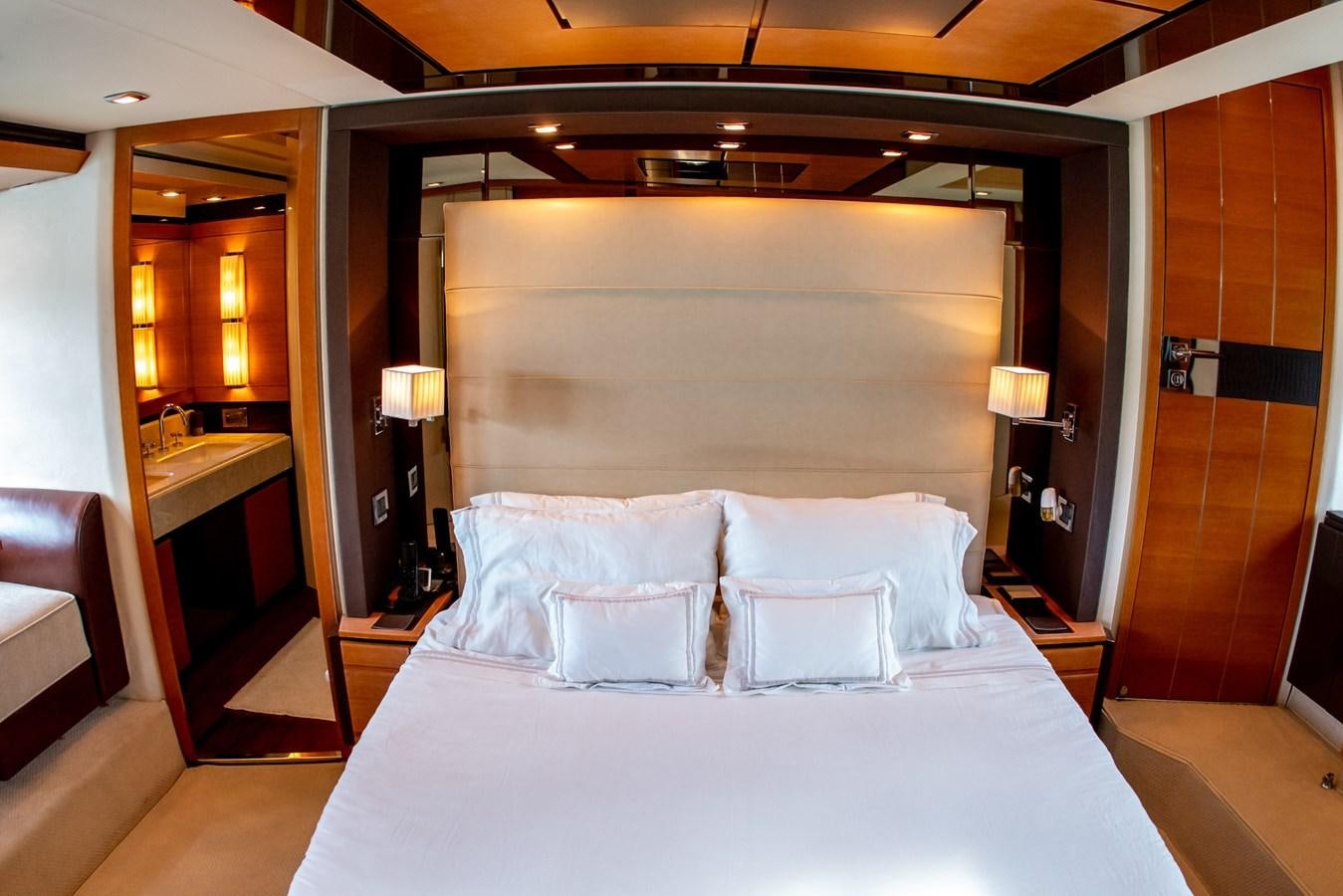 a bed with white sheets aboard VA BENE 2011 AZIMUT 70 FLY Yacht for Sale