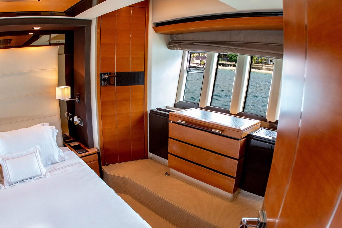 a room with a bed and a window aboard VA BENE 2011 AZIMUT 70 FLY Yacht for Sale
