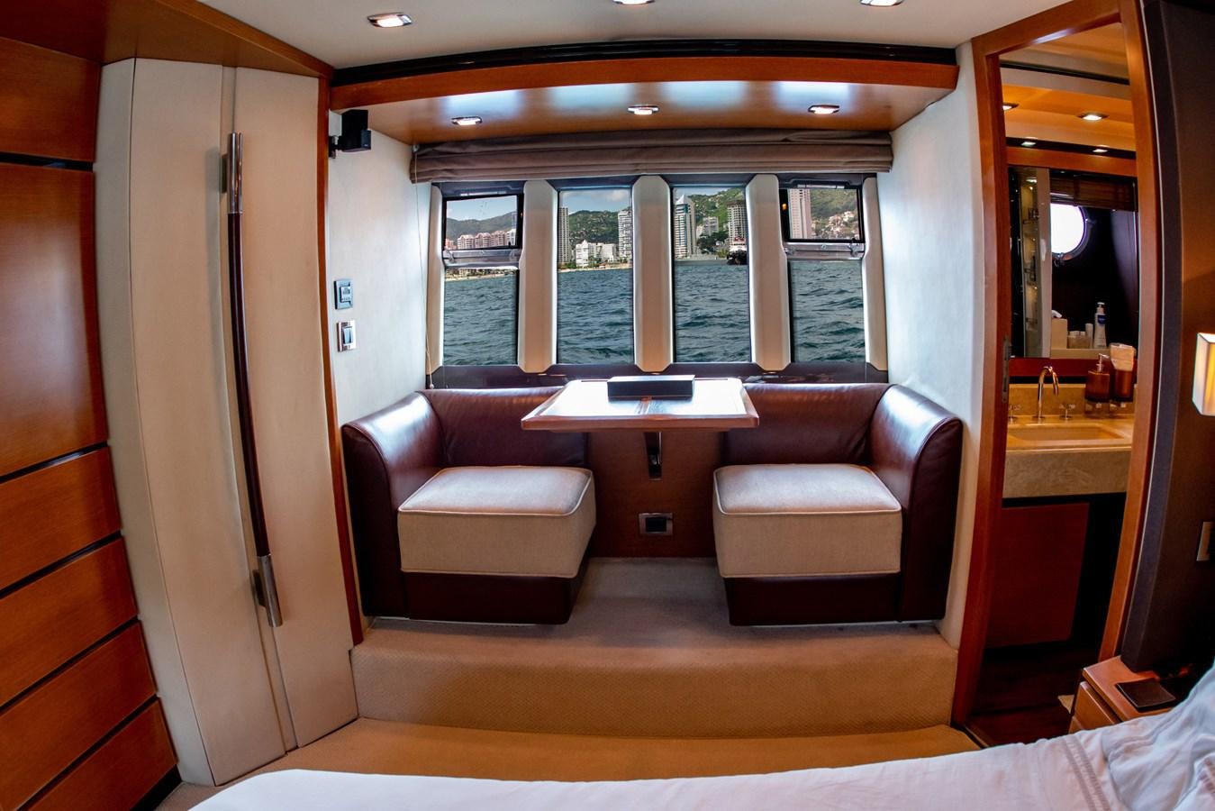 a room with a couch and a table aboard VA BENE 2011 AZIMUT 70 FLY Yacht for Sale