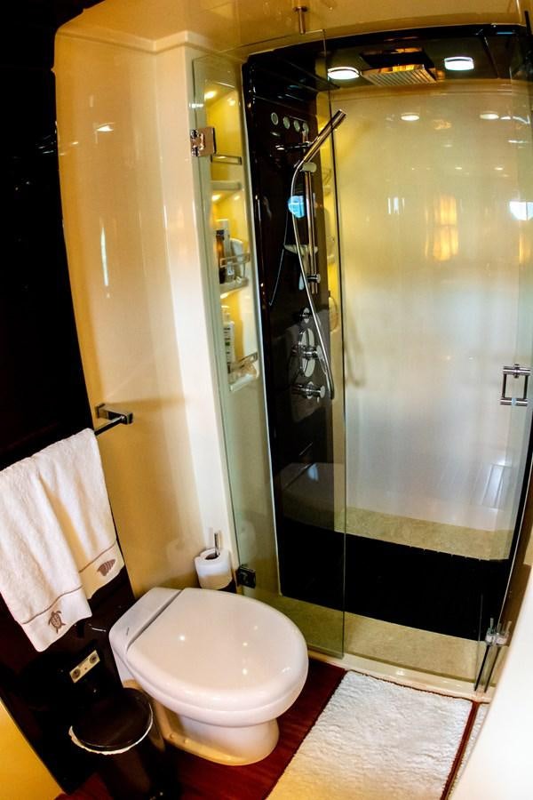 a bathroom with a glass shower aboard VA BENE 2011 AZIMUT 70 FLY Yacht for Sale