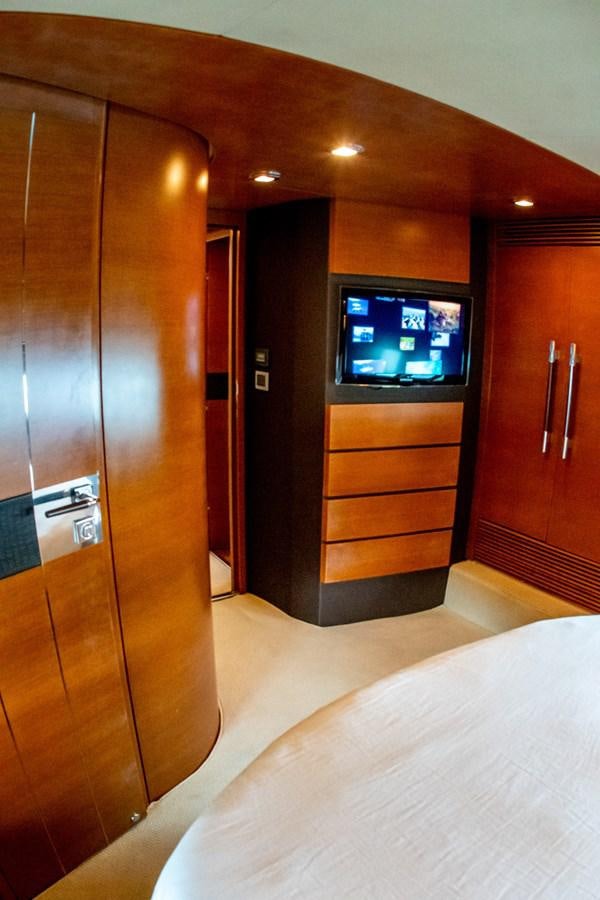 a room with a tv and a bed aboard VA BENE 2011 AZIMUT 70 FLY Yacht for Sale
