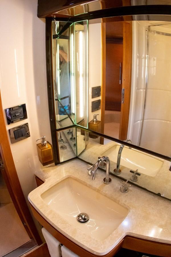 a bathroom with a sink and a mirror aboard VA BENE 2011 AZIMUT 70 FLY Yacht for Sale