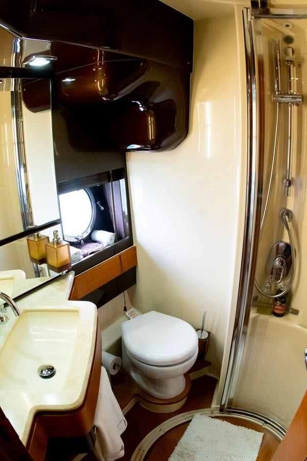 a bathroom with a toilet and sink aboard VA BENE 2011 AZIMUT 70 FLY Yacht for Sale