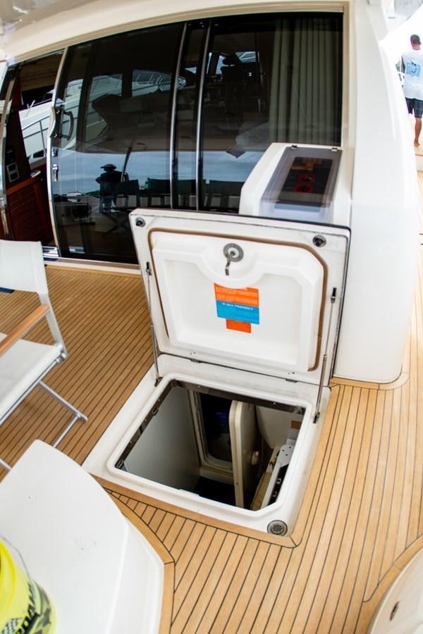 a white rectangular object with a red and blue logo on it aboard VA BENE 2011 AZIMUT 70 FLY Yacht for Sale