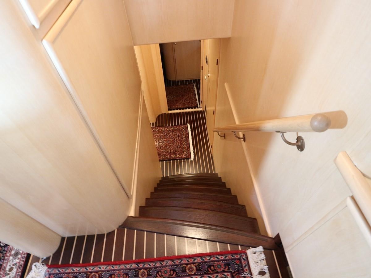 a staircase with a wood railing aboard Polar Princess Yacht for Sale