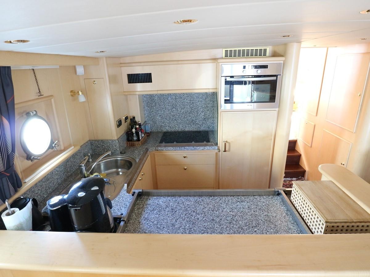 a kitchen with a microwave oven and a sink aboard Polar Princess Yacht for Sale