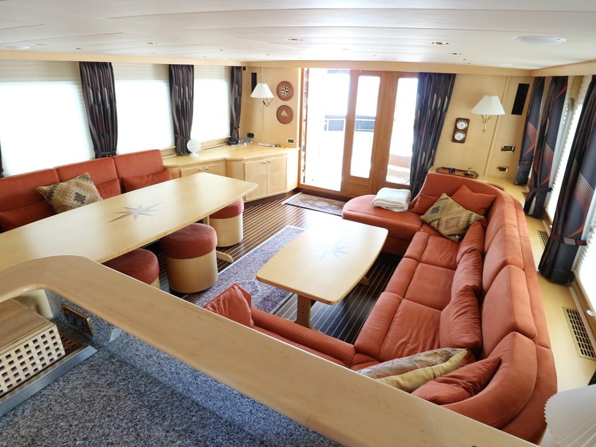 a living room with a couch and a table aboard Polar Princess Yacht for Sale