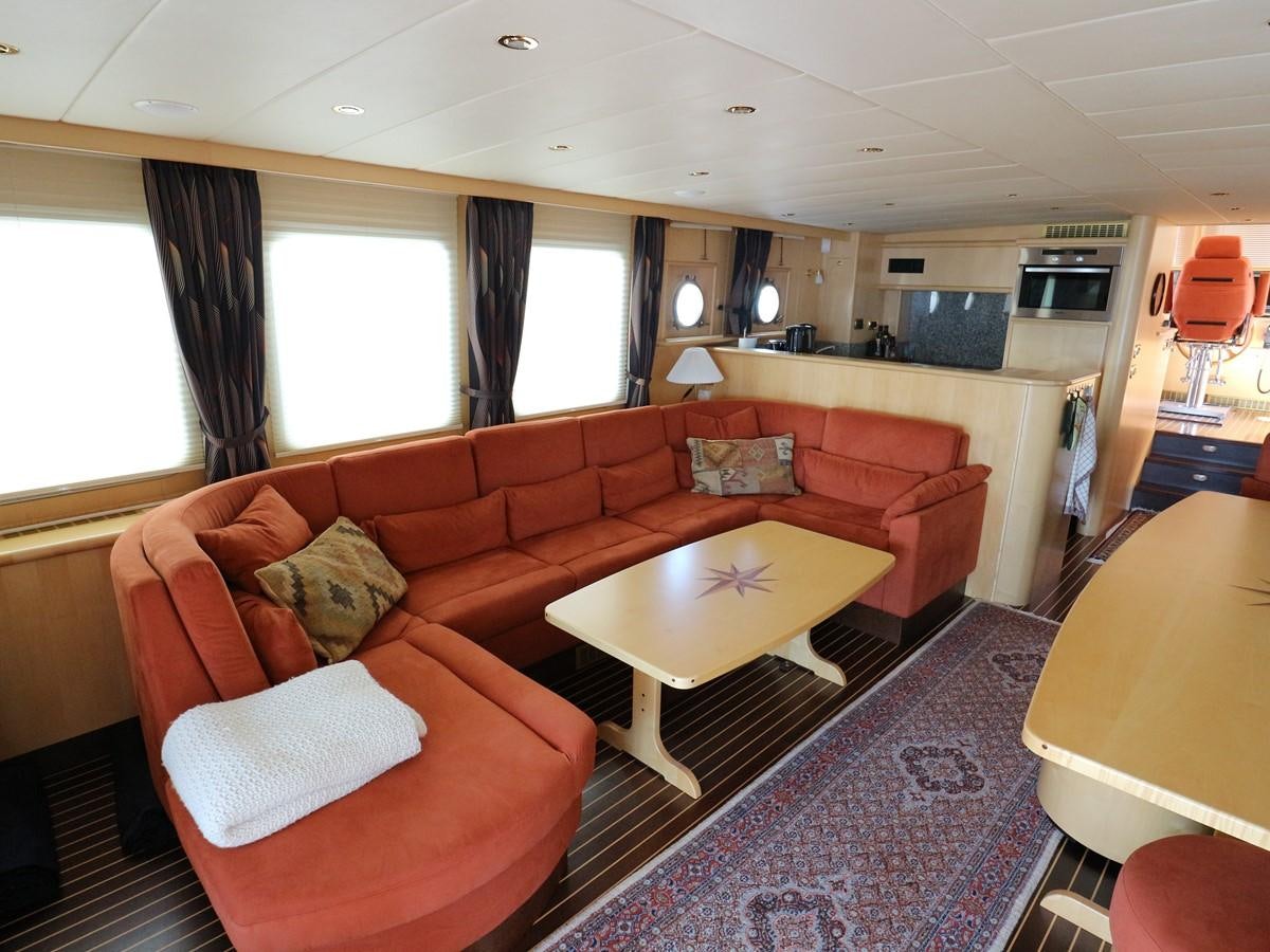 a living room with a couch and a table aboard Polar Princess Yacht for Sale