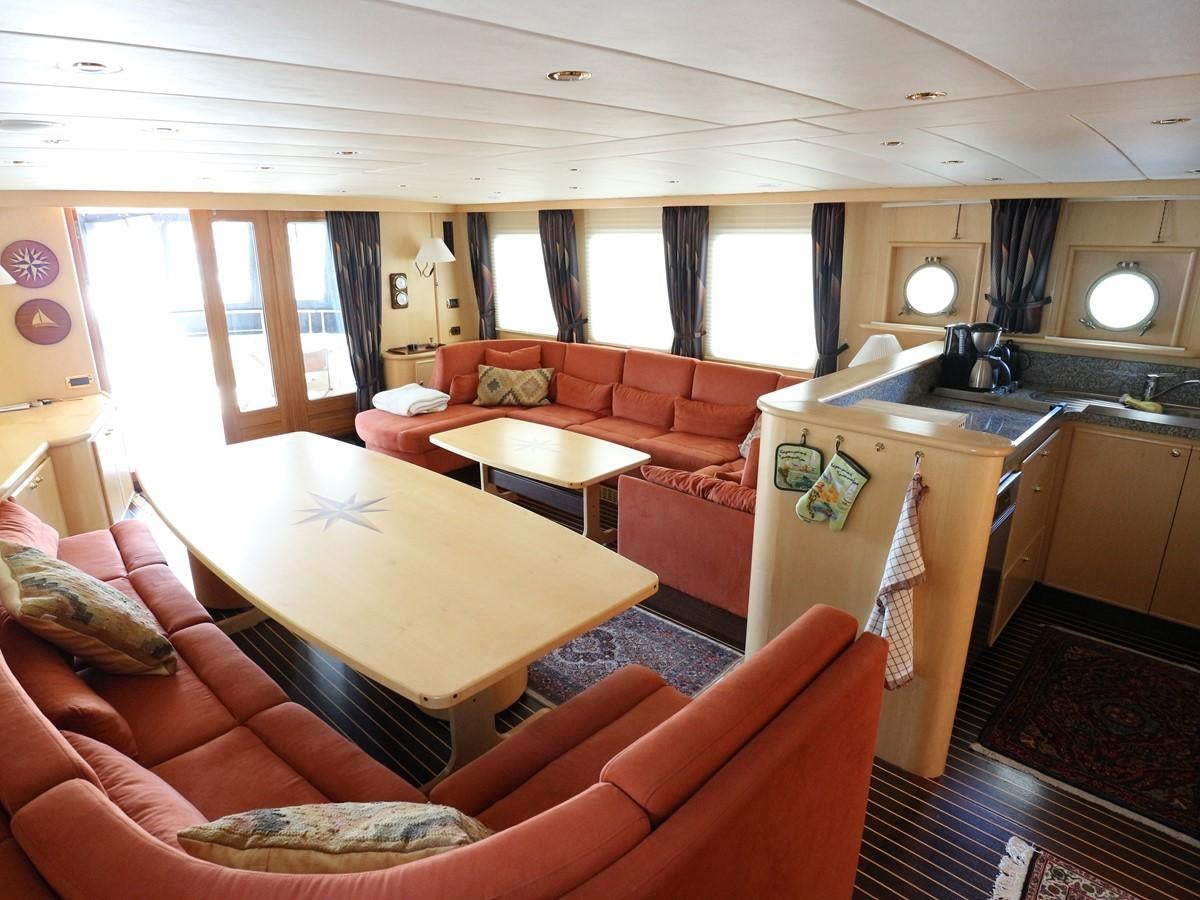 a living room with a kitchen and dining area aboard Polar Princess Yacht for Sale