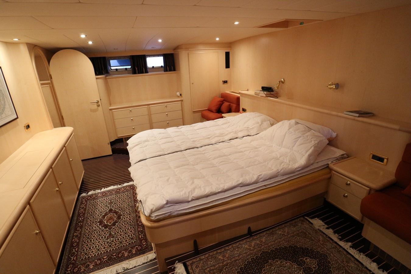 a bedroom with a bed and a chair aboard Polar Princess Yacht for Sale