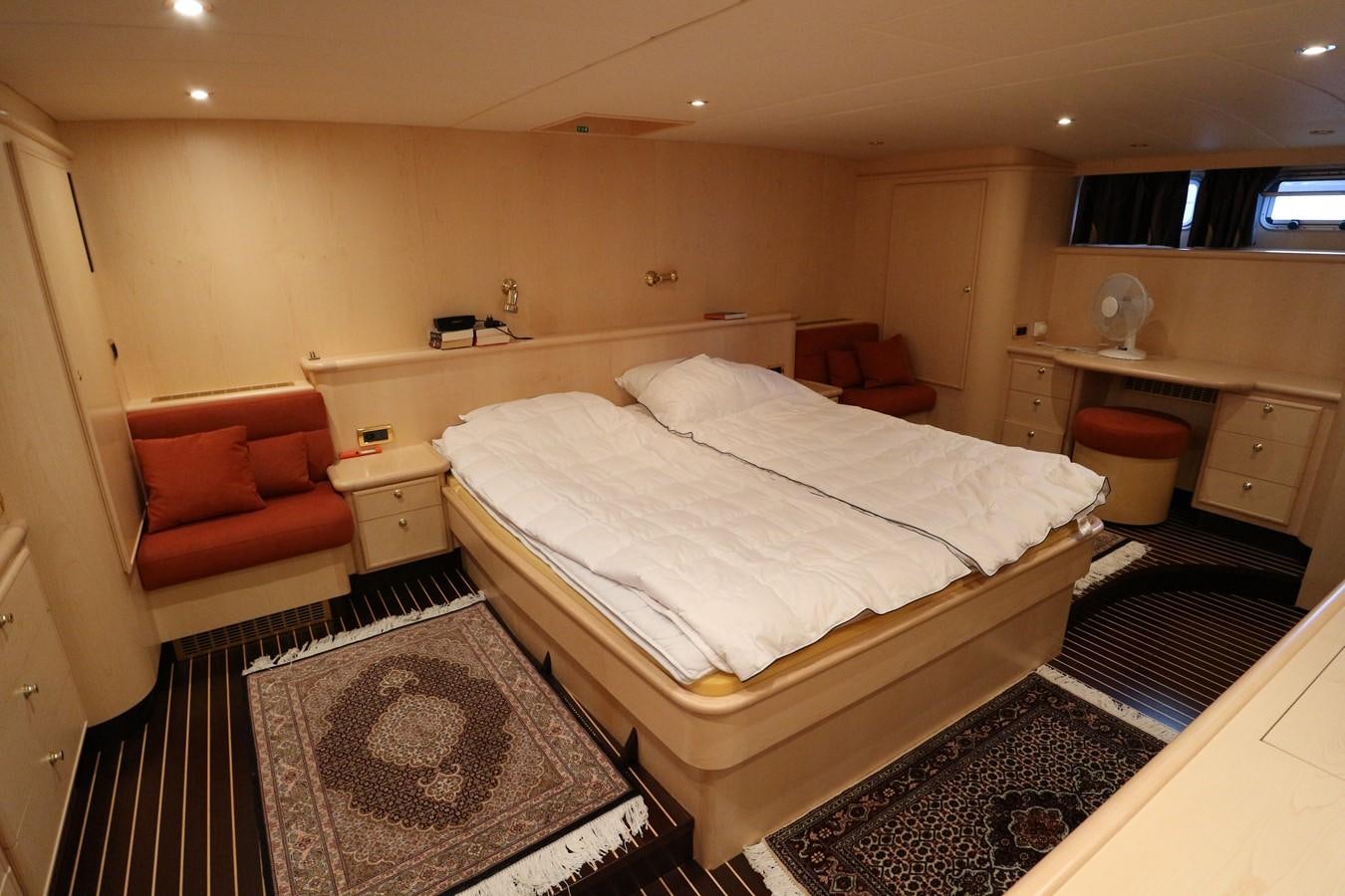a bedroom with a bed and a couch aboard Polar Princess Yacht for Sale