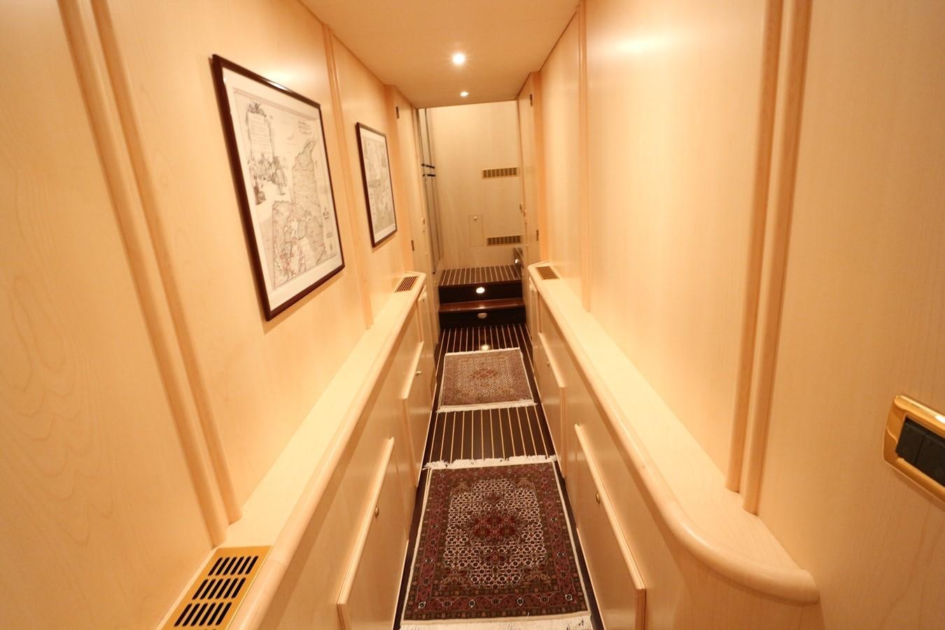 a hallway with a staircase and a rug on the floor aboard Polar Princess Yacht for Sale