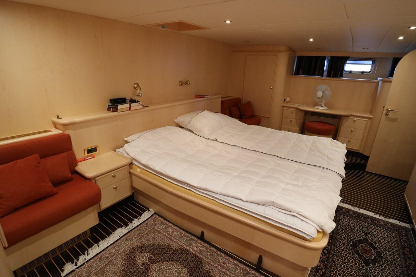a bedroom with a bed and a couch aboard Polar Princess Yacht for Sale