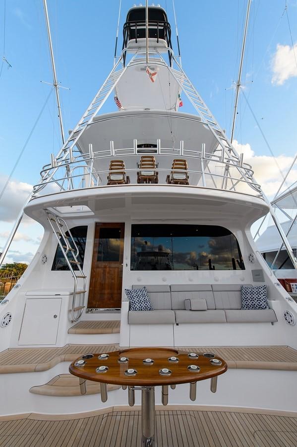a white ship with a table in front of it aboard NOTORIOUS Yacht for Sale