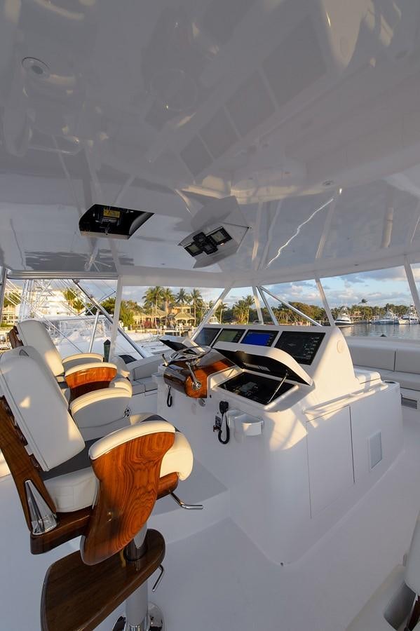 a white tent with a black screen and a red tent and a white tent with trees and grass aboard NOTORIOUS Yacht for Sale