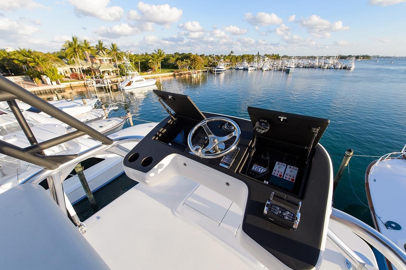 a boat with a steering wheel and a view of a city aboard NOTORIOUS Yacht for Sale