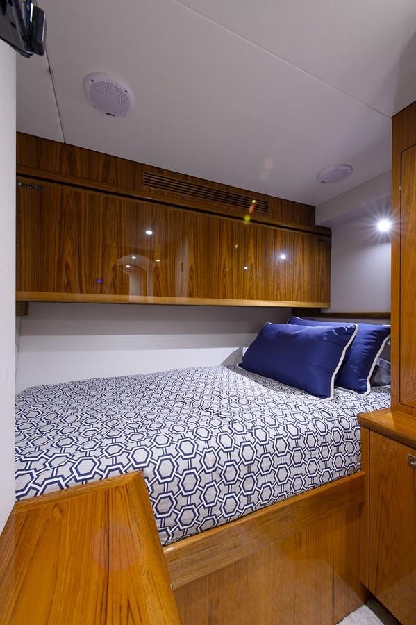 a bed with a white sheet aboard NOTORIOUS Yacht for Sale